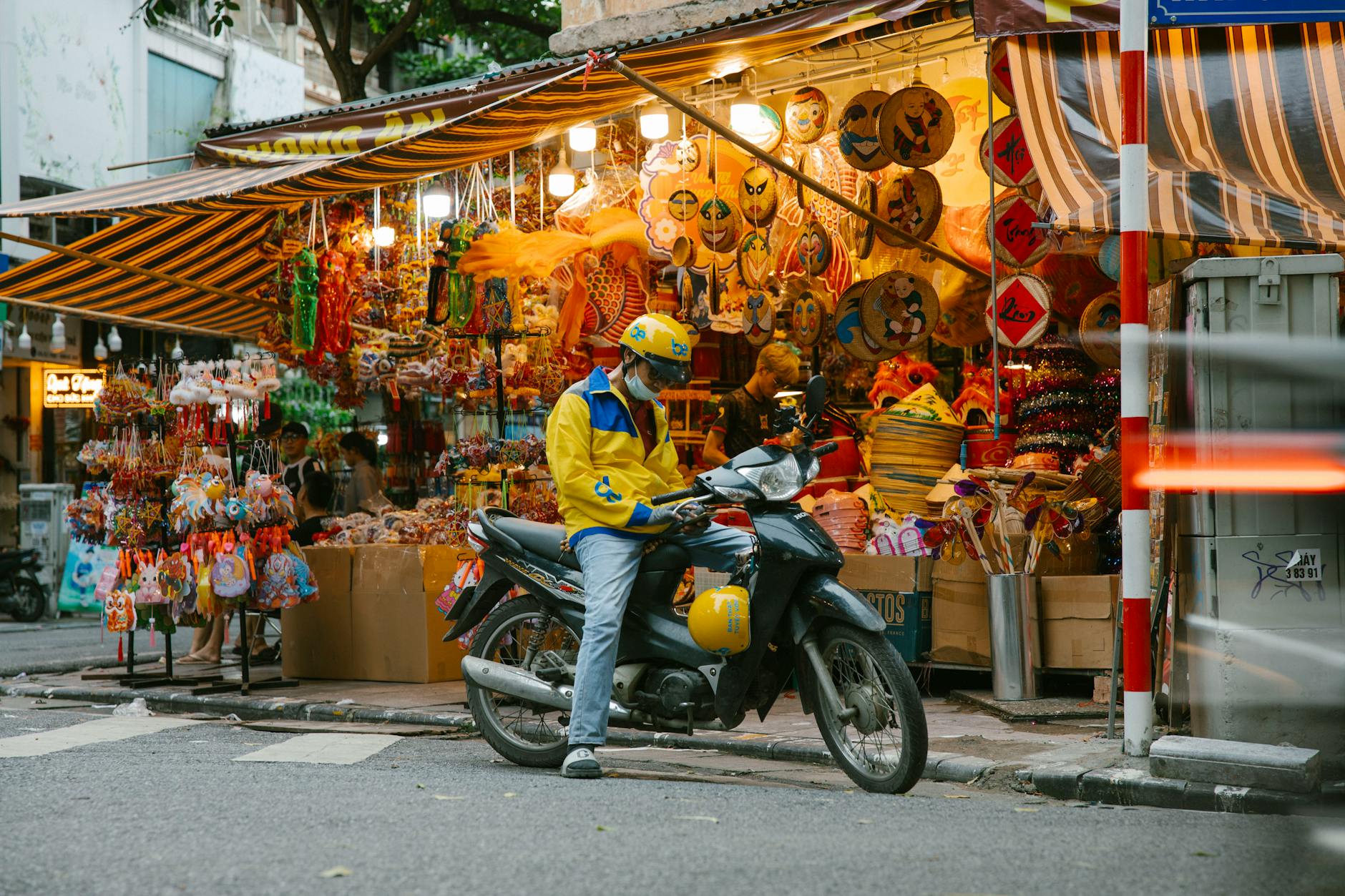 a man on a motorcycle in front of a market