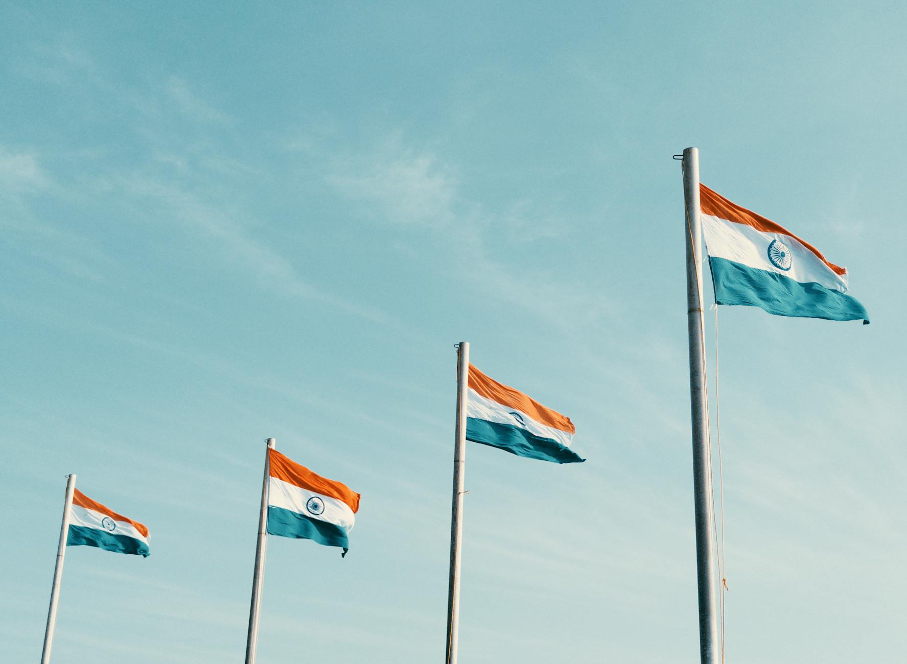 four indian flags fluttering in the breeze
