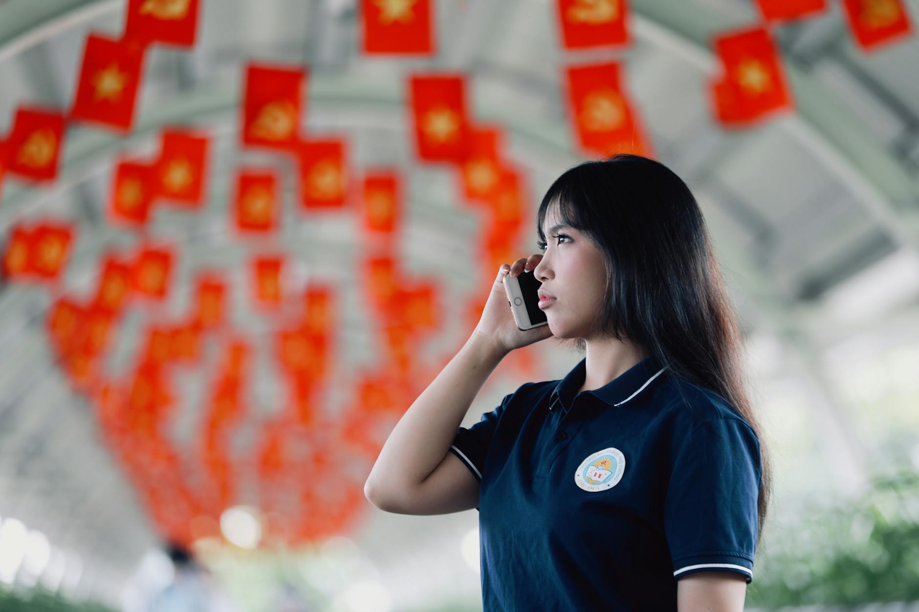 young woman talking on phone in flag corridor