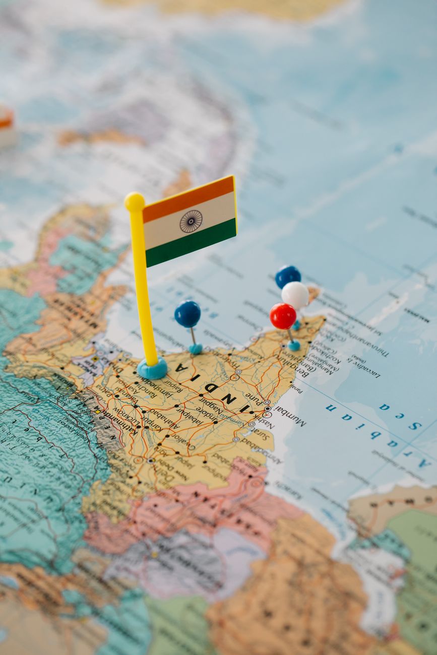 colorful pushpins near the tiny flag