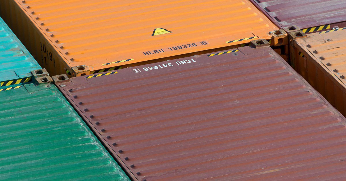 Aerial view of vibrant cargo containers arranged in a pattern, emphasizing logistics and transportation.