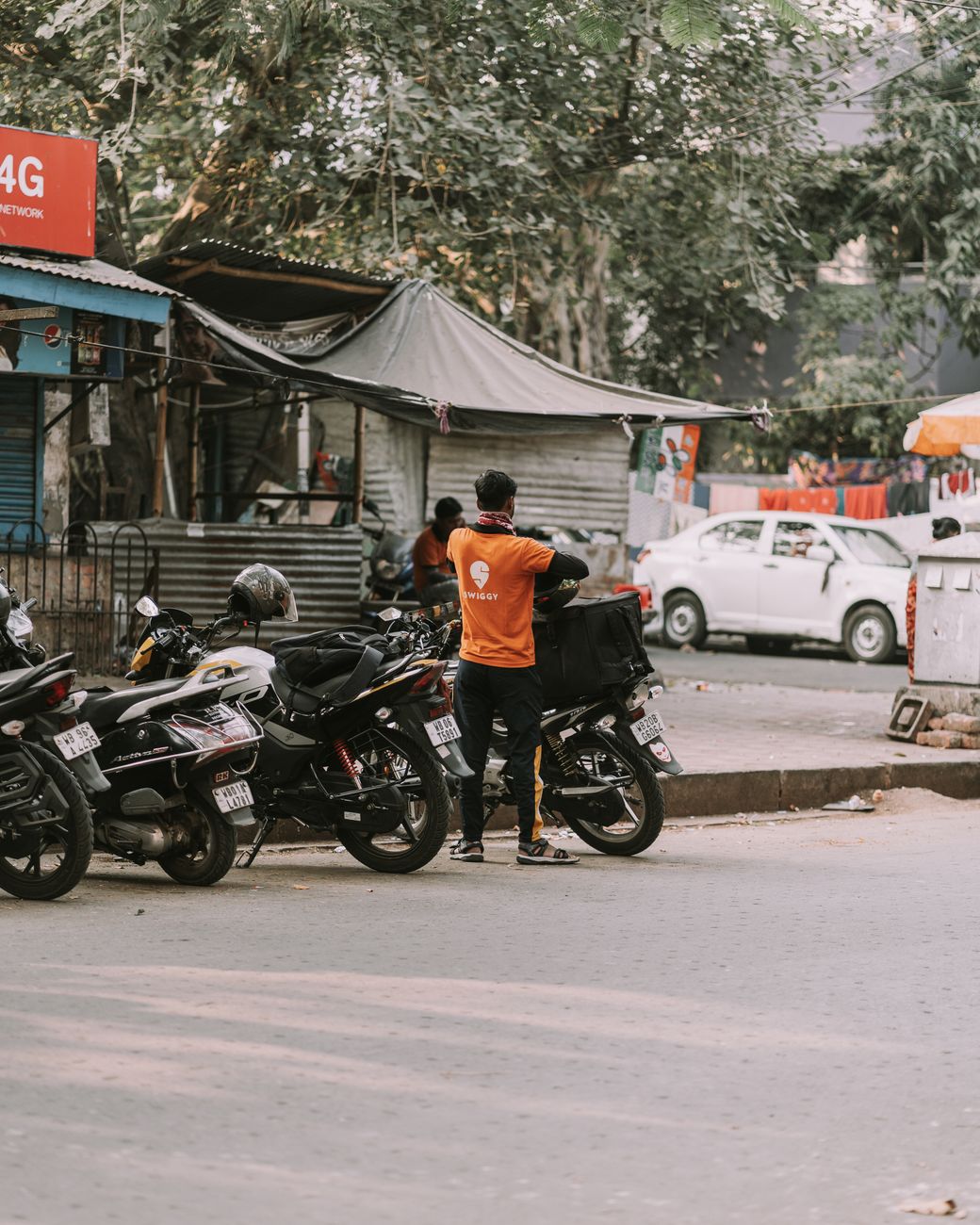 man standing next to motorcycle