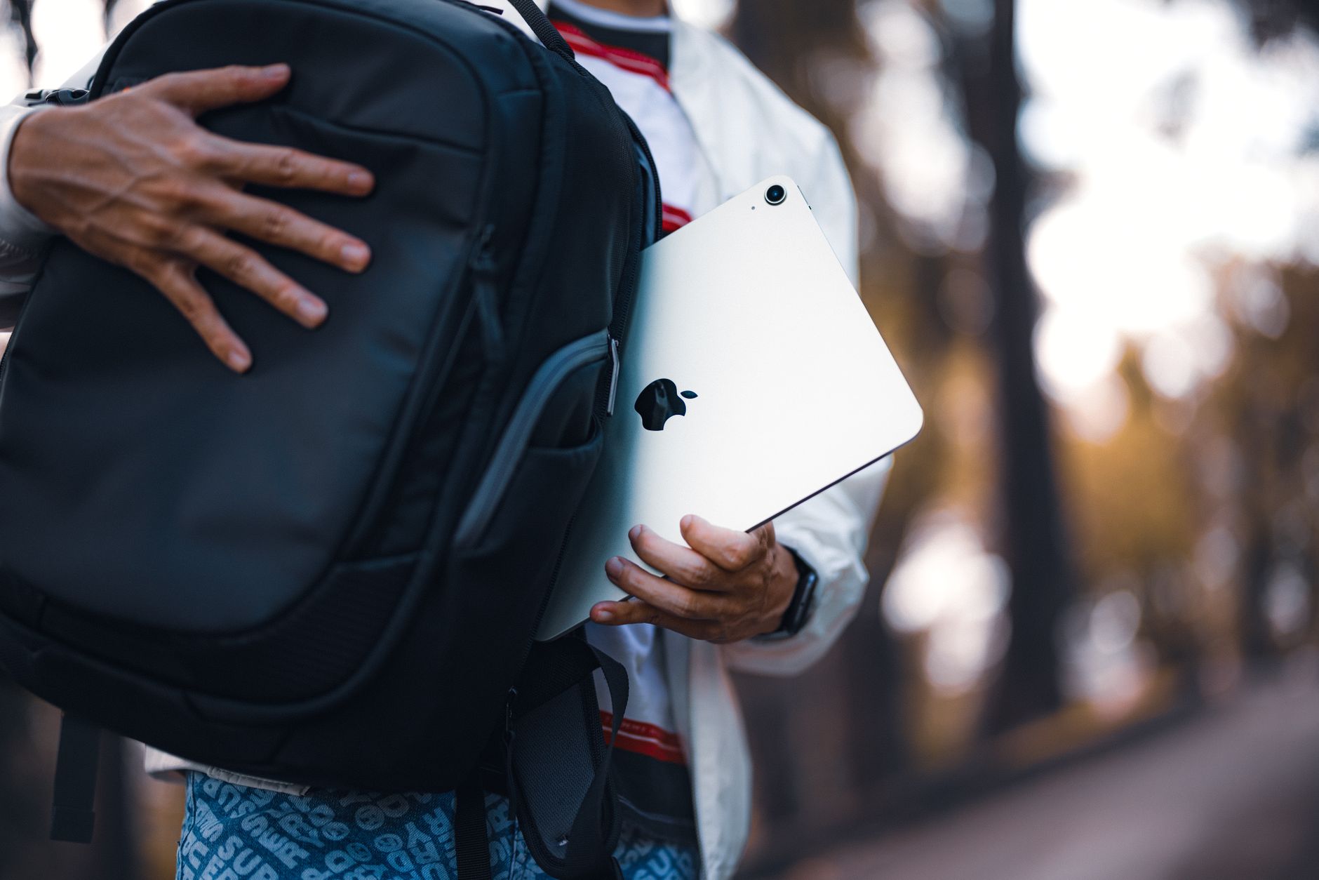 a person putting an ipad on the bag